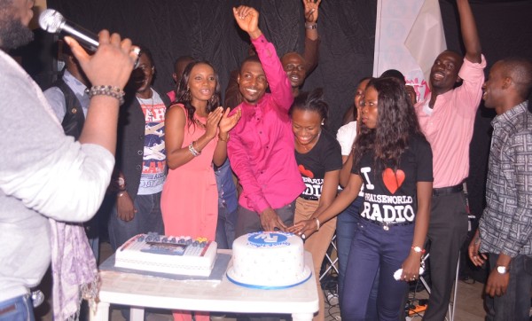 The crowd cheered while the team cut the cake