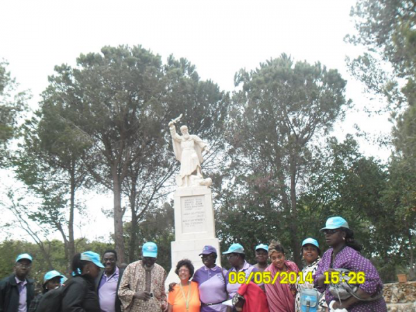 Group of clients in Israel with statue of Prophet Elijah at the background