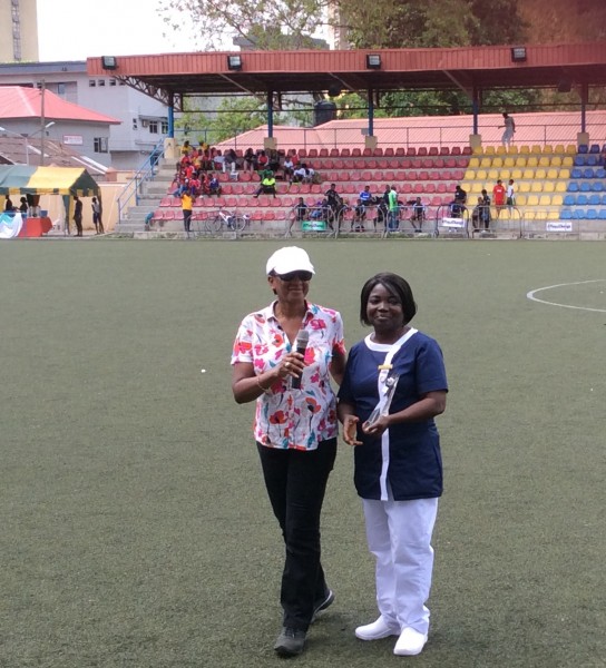 Dr. Roberts honouring a Nurse from First Consultant Hospital